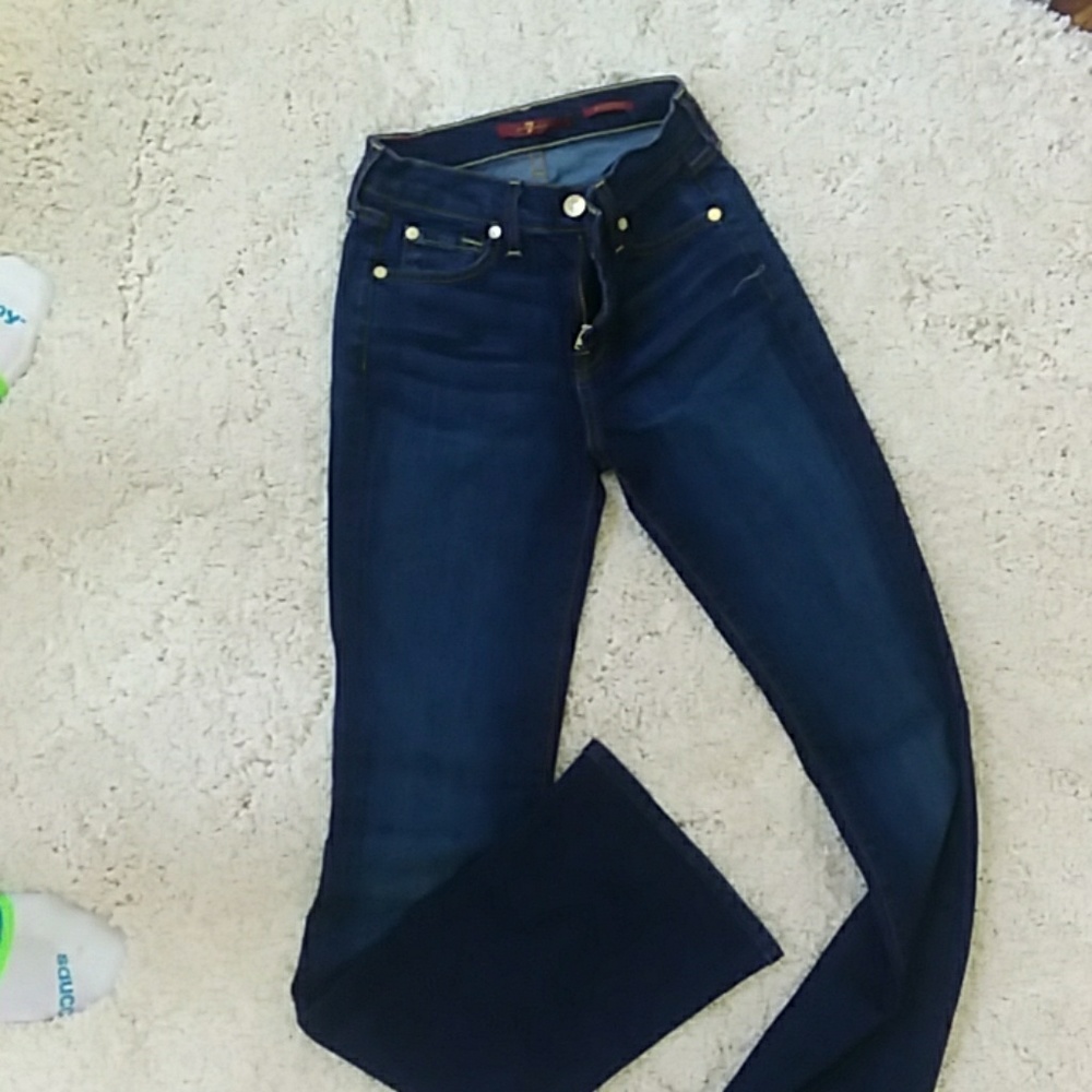 Boot cut, form hugging, mid rise dark navy jeans